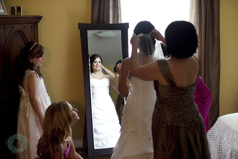 04-bride with her bridesmaids and mother getting dressed