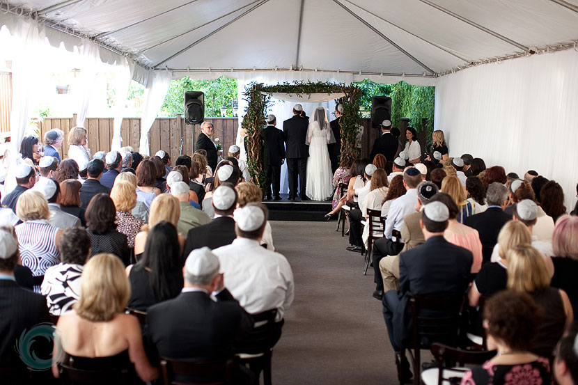 06-guest watch on as the couple stand under the chuppah